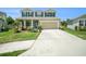 Charming two-story home with well-maintained lawn, two-car garage, and inviting front porch at 18161 Hunters Meadow Walk, Land O Lakes, FL 34638