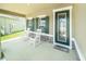 Cozy front porch with decorative door, rocking chairs, and elegant stone accents at 18161 Hunters Meadow Walk, Land O Lakes, FL 34638
