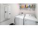 Functional laundry room with washer, dryer and shelving for storage at 18161 Hunters Meadow Walk, Land O Lakes, FL 34638
