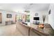 Bright living room features tile flooring, large windows, and a stylish ceiling fan at 18161 Hunters Meadow Walk, Land O Lakes, FL 34638