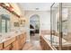 Bright bathroom with a soaking tub and glass shower, leading to the main bedroom at 20347 Chestnut Grove Dr, Tampa, FL 33647