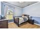 Comfortable bedroom with a cozy bed, soft carpet, and a charming view from the window at 20347 Chestnut Grove Dr, Tampa, FL 33647