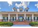 Inviting clubhouse entrance with brick stairs, decorative railings, and stately columns, providing a welcoming community focal point at 20347 Chestnut Grove Dr, Tampa, FL 33647
