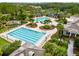 Aerial view of multiple community pools, including a lap pool, with ample seating, landscaping, and resort-like amenities at 20347 Chestnut Grove Dr, Tampa, FL 33647