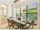 Bright dining room featuring a large window with views of landscaped outdoor space at 20347 Chestnut Grove Dr, Tampa, FL 33647