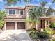 Stately two-story home with a two-car garage, lush landscaping, and a well-manicured lawn at 20347 Chestnut Grove Dr, Tampa, FL 33647