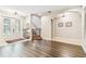 Open-concept foyer featuring hardwood floors, staircase, and front door entryway at 20347 Chestnut Grove Dr, Tampa, FL 33647