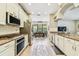 Bright kitchen with stainless steel appliances and granite countertops showcases a seamless transition into the adjacent dining area at 20347 Chestnut Grove Dr, Tampa, FL 33647