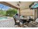 Covered outdoor patio with a built-in grill, ample seating, and a serene view of the pool at 20347 Chestnut Grove Dr, Tampa, FL 33647