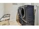 Laundry room with modern washer and dryer, plus storage and ironing equipment at 20347 Chestnut Grove Dr, Tampa, FL 33647