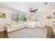 Bright living room features a large sectional couch, natural light, and dark, hard wood floors at 20347 Chestnut Grove Dr, Tampa, FL 33647