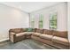 Spacious living room with large sectional couch, neutral walls, and natural light at 20347 Chestnut Grove Dr, Tampa, FL 33647