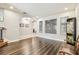 Spacious living room featuring hardwood floors, an arched doorway, and natural light at 20347 Chestnut Grove Dr, Tampa, FL 33647