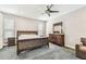 Main bedroom features stylish wood furniture, window with blinds, and neutral colored walls at 20347 Chestnut Grove Dr, Tampa, FL 33647