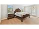 Bedroom featuring carpet, neutral paint, large windows and a dark wood dresser at 20347 Chestnut Grove Dr, Tampa, FL 33647