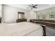 Large main bedroom with a ceiling fan, dresser, and a comfortable-looking sectional at 20347 Chestnut Grove Dr, Tampa, FL 33647
