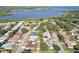 Aerial view of neighborhood homes near the lake, featuring mature trees and lush landscaping at 206 Timberview Dr, Safety Harbor, FL 34695