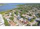 Suburban aerial view showcasing houses by the lake with mature trees and lush landscaping at 206 Timberview Dr, Safety Harbor, FL 34695