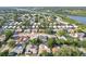 An aerial view of the neighborhood highlights the homes, landscaping and proximity to a nearby river at 206 Timberview Dr, Safety Harbor, FL 34695