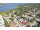 Suburban aerial view showcasing houses by the lake with mature trees and lush landscaping at 206 Timberview Dr, Safety Harbor, FL 34695