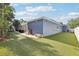 Spacious backyard with lush artificial turf, a patio, and ample room for outdoor activities at 206 Timberview Dr, Safety Harbor, FL 34695