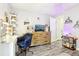 This bedroom offers a comfortable desk, chair, shelves, dresser, and cheerful decor at 206 Timberview Dr, Safety Harbor, FL 34695