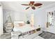 Charming bedroom boasts unique hanging chair, soft colors, and sleek plank flooring for a serene retreat at 206 Timberview Dr, Safety Harbor, FL 34695