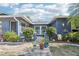 Charming single-story home with a brick driveway and walkway leading to the front door at 206 Timberview Dr, Safety Harbor, FL 34695