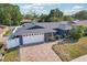 Well-maintained home with a brick driveway, two-car garage, and manicured lawn at 206 Timberview Dr, Safety Harbor, FL 34695