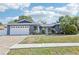 Charming one-story home with a well-manicured front yard, beautiful landscaping, and a brick driveway at 206 Timberview Dr, Safety Harbor, FL 34695