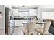 Kitchen boasts a black granite countertop island with seating, stainless steel appliances, and white cabinetry at 206 Timberview Dr, Safety Harbor, FL 34695