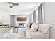 Bright living room with gray walls, gray furniture, a large screen television, and a gray ceiling fan at 206 Timberview Dr, Safety Harbor, FL 34695