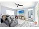 Cozy living room features sleek ceiling fan, plank floors, and large TV for ultimate relaxation at 206 Timberview Dr, Safety Harbor, FL 34695