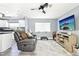 Inviting living room showcases comfortable gray sofa, plush rug, and entertainment center near the kitchen at 206 Timberview Dr, Safety Harbor, FL 34695