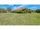 Beautiful backyard with lush green grass and tropical landscaping at 218 Pesaro Dr, North Venice, FL 34275