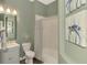 Comfortable bathroom includes seafoam paint, new hardware and turtle artwork at 218 Pesaro Dr, North Venice, FL 34275