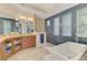 Luxurious bathroom featuring a freestanding tub, stylish blue tile accents, and abundant natural light at 218 Pesaro Dr, North Venice, FL 34275