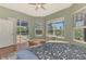 Cozy bedroom offers an attached screened in patio with a pool view and hard wood floors at 218 Pesaro Dr, North Venice, FL 34275