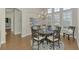 Cozy dining room featuring a round table, decorative chairs, and natural light through shuttered windows at 218 Pesaro Dr, North Venice, FL 34275