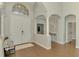 Grand foyer features tall ceilings, architectural columns, wood floors, and a bright entrance at 218 Pesaro Dr, North Venice, FL 34275