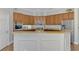Well-equipped kitchen with granite countertops, a stainless steel refrigerator, and wooden cabinetry at 218 Pesaro Dr, North Venice, FL 34275
