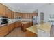 Spacious kitchen features custom wood cabinetry, stainless appliances, and granite countertops at 218 Pesaro Dr, North Venice, FL 34275