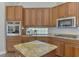 Close up of the kitchen with stainless appliances, granite countertops, and wood cabinets at 218 Pesaro Dr, North Venice, FL 34275