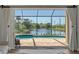 View from the living room to the screened lanai with pool overlooking the lake at 218 Pesaro Dr, North Venice, FL 34275