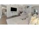 Bright living room showcasing a contemporary design with an elegant grey sofa and modern decor accents at 218 Pesaro Dr, North Venice, FL 34275