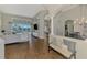 Spacious living area with wood floors, architectural columns, and views of the pool and dining area at 218 Pesaro Dr, North Venice, FL 34275