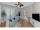 Bright living room with wood floors, ceiling fan, and french doors provide lots of light at 218 Pesaro Dr, North Venice, FL 34275