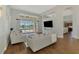 Bright living room features stylish furniture, wood floors, and a view of the screened pool area at 218 Pesaro Dr, North Venice, FL 34275