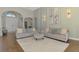 Elegant living room featuring matching sofas, a patterned rug, and sophisticated wall decor at 218 Pesaro Dr, North Venice, FL 34275