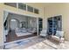 Covered patio offering an indoor-outdoor living space with sliding doors to the main living area at 218 Pesaro Dr, North Venice, FL 34275